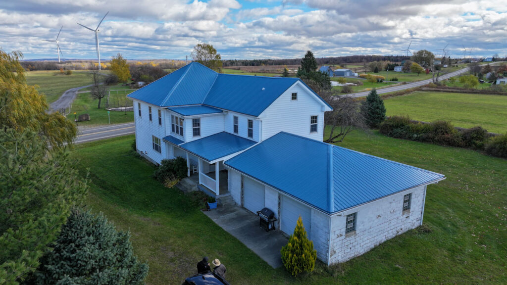 Amish-built-blue-metal-roof-on-white-farmhouse-DT-Hostetlers